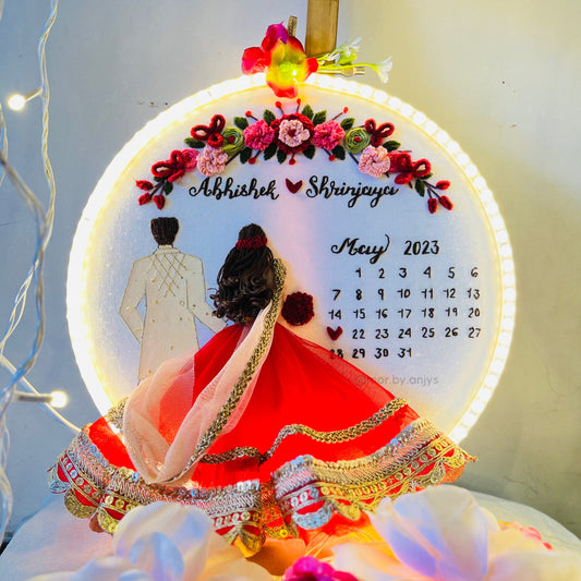 Decorative calendar with floral design and couple illustration, featuring the month of May 2023.